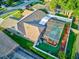 Aerial view showcasing a sparkling screened-in pool, lush landscaping, and fenced-in yard at 680 Cheoy Lee Cir, Winter Springs, FL 32708