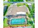Aerial view of backyard pool area with screened lanai, spa, fenced yard, mature landscaping and small putting green at 680 Cheoy Lee Cir, Winter Springs, FL 32708