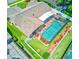 Aerial view of backyard with pool, spa, screened in patio, and manicured landscape at 680 Cheoy Lee Cir, Winter Springs, FL 32708