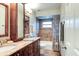Bathroom features a double vanity with granite countertops, matching mirrors, and a shower/tub combo at 680 Cheoy Lee Cir, Winter Springs, FL 32708