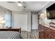 Bedroom featuring hardwood floors, ceiling fan, closet and ample natural light from the window at 680 Cheoy Lee Cir, Winter Springs, FL 32708