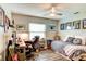 Well lit bedroom including a desk, bed, hardwood floors, and ceiling fan at 680 Cheoy Lee Cir, Winter Springs, FL 32708