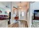 Welcoming entryway with wood-look floors, elegant lighting, and stylish decor sets a sophisticated tone at 680 Cheoy Lee Cir, Winter Springs, FL 32708