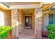Charming covered front porch entrance framed by brick pillars and colorful summer decor at 680 Cheoy Lee Cir, Winter Springs, FL 32708