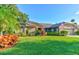 Beautiful home with lush landscaping, mature trees, and a well-manicured lawn at 680 Cheoy Lee Cir, Winter Springs, FL 32708