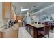 Spacious kitchen with granite counters, stainless appliances, island seating, and a skylight at 680 Cheoy Lee Cir, Winter Springs, FL 32708