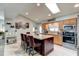 Kitchen includes a large island with seating and stainless appliances with a bright skylight overhead at 680 Cheoy Lee Cir, Winter Springs, FL 32708