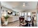 Open living area features a ceiling fan, laminate floors, and a large dining space at 680 Cheoy Lee Cir, Winter Springs, FL 32708