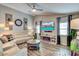 Comfortable living room with modern furniture, stylish flooring, and an electric fireplace at 680 Cheoy Lee Cir, Winter Springs, FL 32708