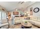 Open living space with wood floors features a comfortable sofa and view of dining area at 680 Cheoy Lee Cir, Winter Springs, FL 32708