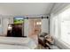 Comfortable bedroom featuring a sliding barn door that leads to the bathroom with shower at 680 Cheoy Lee Cir, Winter Springs, FL 32708