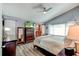 Comfortable bedroom featuring a ceiling fan, vaulted ceilings and a dresser with a television at 680 Cheoy Lee Cir, Winter Springs, FL 32708