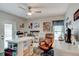 Inviting office space complete with craft and sewing tables, hardwood floors, and natural light from windows at 680 Cheoy Lee Cir, Winter Springs, FL 32708