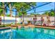 Inviting pool and spa with landscaping, a privacy fence, overhead lighting, and an outdoor area for entertaining at 680 Cheoy Lee Cir, Winter Springs, FL 32708