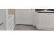 Bathroom features a tub, toilet, cabinets, and a door at 710 Siena Palm Dr # 104, Celebration, FL 34747