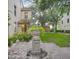 Serene courtyard featuring a stone fountain and lush landscaping at 710 Siena Palm Dr # 104, Celebration, FL 34747