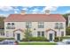 Attractive two-story building showcasing a red tile roof and manicured front yard at 710 Siena Palm Dr # 104, Celebration, FL 34747