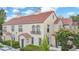 Charming two-story townhouse featuring a red tile roof and lush landscaping at 710 Siena Palm Dr # 104, Celebration, FL 34747