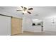 A spacious living room with a barn door and a ceiling fan at 710 Siena Palm Dr # 104, Celebration, FL 34747