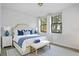 This is a main bedroom that has a bed and two windows and decor in blue colors at 710 Siena Palm Dr # 104, Celebration, FL 34747