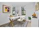 This staged office has a white desk with gold accents, a black and white rug, and natural light at 710 Siena Palm Dr # 104, Celebration, FL 34747