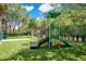 A vibrant playground area with slides, climbing structures, artificial turf, and swingset at 710 Siena Palm Dr # 104, Celebration, FL 34747