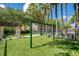 Community playground area with swingset, artificial turf, and shaded seating area at 710 Siena Palm Dr # 104, Celebration, FL 34747