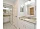 Bright bathroom with white cabinetry, granite countertops, and double sinks for added convenience at 7104 Olympia Ct # 7104, Longwood, FL 32779