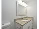 Elegant bathroom vanity with granite countertop, white cabinetry, and modern fixtures at 7104 Olympia Ct # 7104, Longwood, FL 32779