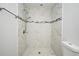 Modern bathroom shower featuring marble-style tile and a rainfall showerhead for a spa-like experience at 7104 Olympia Ct # 7104, Longwood, FL 32779