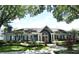 Attractive clubhouse framed by mature trees and featuring manicured landscaping and classic architectural design at 7104 Olympia Ct # 7104, Longwood, FL 32779