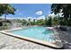 Enjoy the community's beautiful pool with ample seating, surrounded by lush landscaping and serene atmosphere at 7104 Olympia Ct # 7104, Longwood, FL 32779