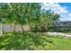 Fenced backyard with green grass, lovely landscaping, and a trampoline for outdoor fun at 8713 Iron Mountain Trl, Windermere, FL 34786