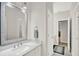 Well-lit bathroom showcasing vanity with a gray-framed mirror and access to the toilet and hallway at 8713 Iron Mountain Trl, Windermere, FL 34786