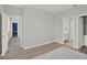 Bright bedroom displaying wood-style flooring, and access to the hallway, bathroom, and walk-in closet at 8713 Iron Mountain Trl, Windermere, FL 34786