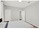This bedroom features neutral walls, a bed with a white and gray comforter, and access to other rooms at 8713 Iron Mountain Trl, Windermere, FL 34786