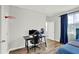 Bedroom showcasing a desk with gaming equipment, wood floors, and ample natural light from the window at 8713 Iron Mountain Trl, Windermere, FL 34786