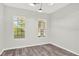 Bright bonus room with natural light, modern light fixture, and hardwood floors at 8713 Iron Mountain Trl, Windermere, FL 34786