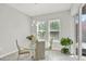 Bright breakfast nook with glass table, modern chandelier, and sliding doors to a backyard patio at 8713 Iron Mountain Trl, Windermere, FL 34786