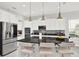 Modern kitchen with stainless appliances, granite counters and seating at the island at 8713 Iron Mountain Trl, Windermere, FL 34786