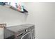 A large laundry room features modern gray front-load washer and dryer at 8713 Iron Mountain Trl, Windermere, FL 34786