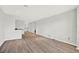Spacious, bright living room with modern wood-look floors and open concept layout to other rooms at 8713 Iron Mountain Trl, Windermere, FL 34786