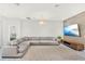 Spacious living room with a comfortable sectional sofa and a modern media center at 8713 Iron Mountain Trl, Windermere, FL 34786