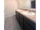 Bathroom features double sinks, spacious countertop, and tile flooring at 9033 Alba Ln, Kissimmee, FL 34747