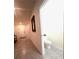 Modern powder room featuring sleek fixtures, tiled floors, and a convenient layout at 9033 Alba Ln, Kissimmee, FL 34747