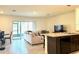 Open floor plan featuring a modern kitchen, dining area, and a spacious living room at 9033 Alba Ln, Kissimmee, FL 34747