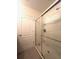 Shower stall with glass doors and a tiled surround at 9033 Alba Ln, Kissimmee, FL 34747
