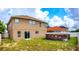 Exterior view of the home with a large yard, above-ground pool and lush green landscaping at 1033 Sabine Pl, Kissimmee, FL 34759