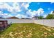 Spacious backyard featuring privacy fence, partial above-ground pool and lush green landscaping at 1033 Sabine Pl, Kissimmee, FL 34759