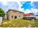 Exterior view of the home with a large yard, above-ground pool and lush green landscaping at 1033 Sabine Pl, Kissimmee, FL 34759